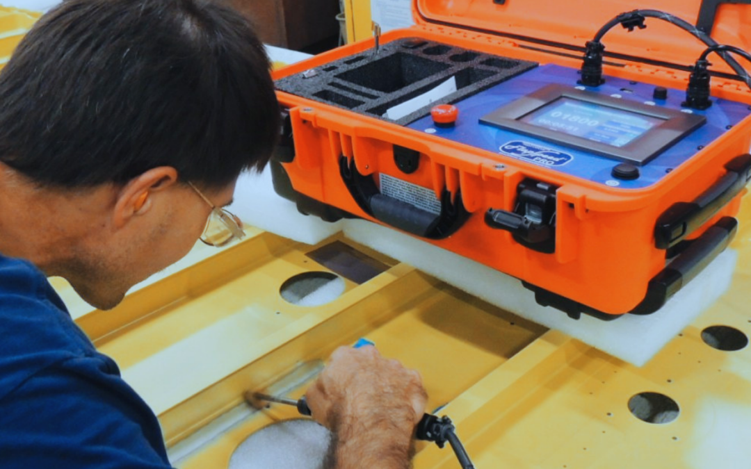 Operator performing a roto-peening operation with the Shockform FlapSpeed® PRO on a structure